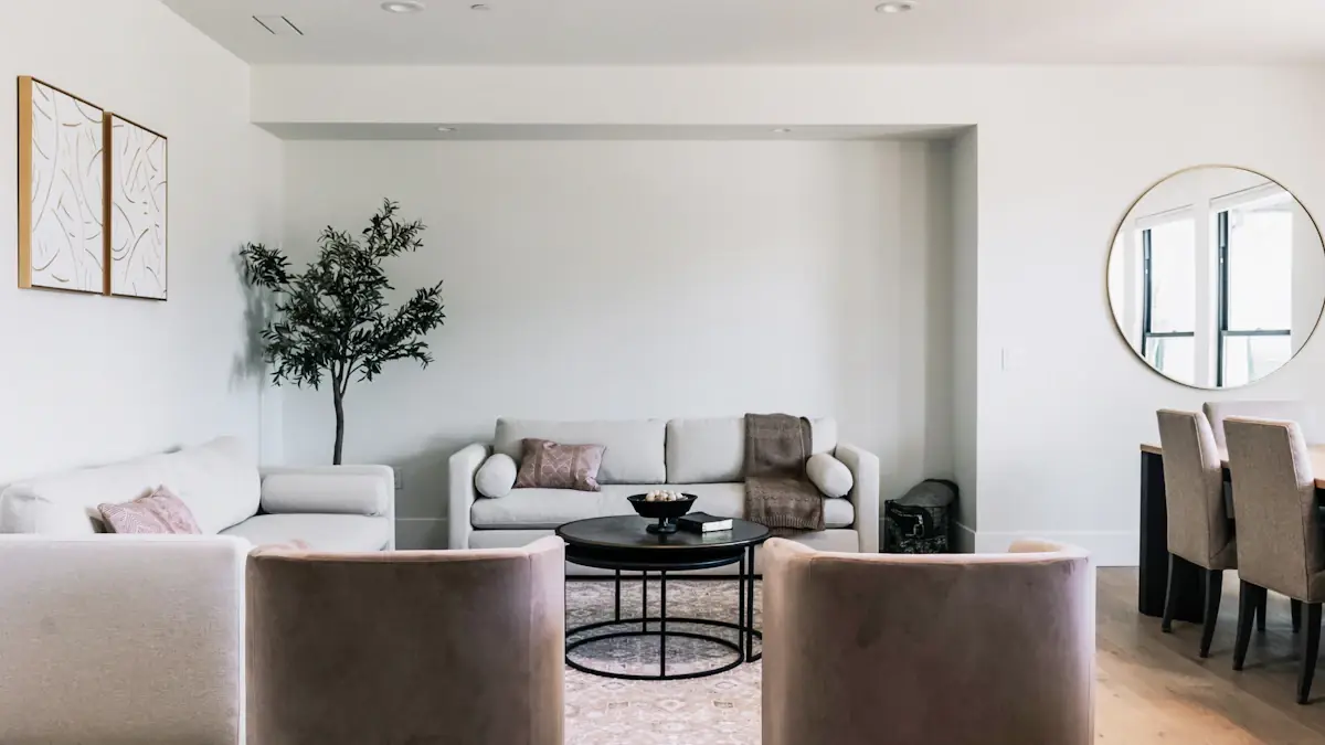 Bright living room with a sofa, chairs and a coffee table for a furniture campaign.